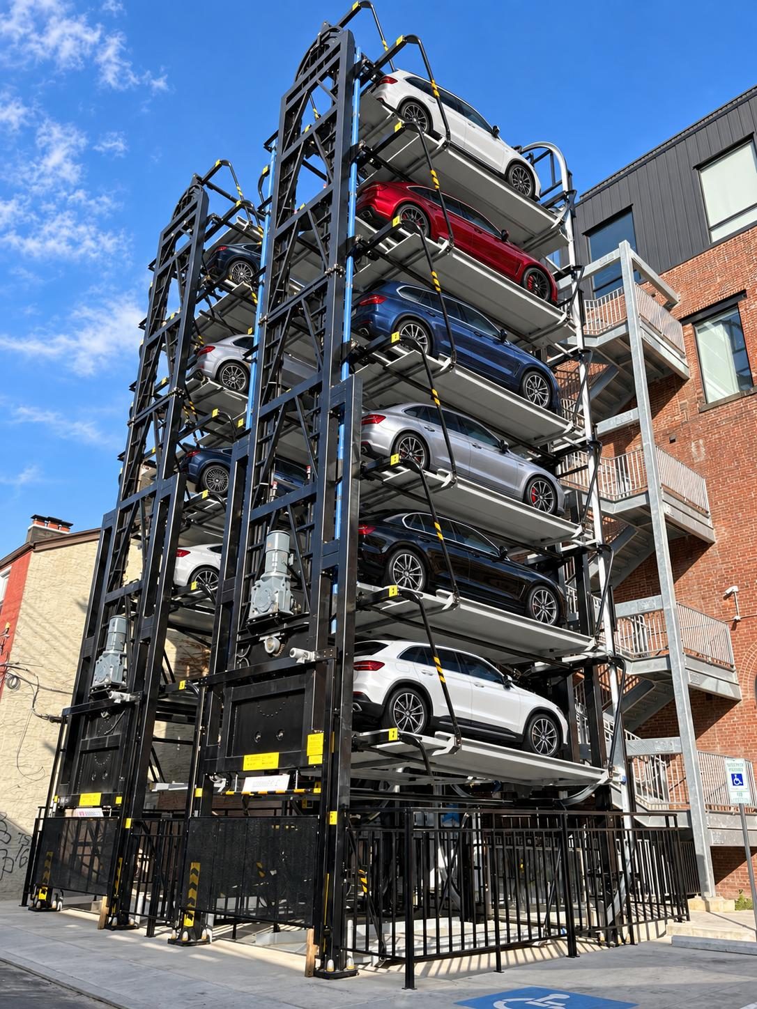 Carousel tower filled with vehicles beside a residential building in Pittsburgh, Pennsylvania