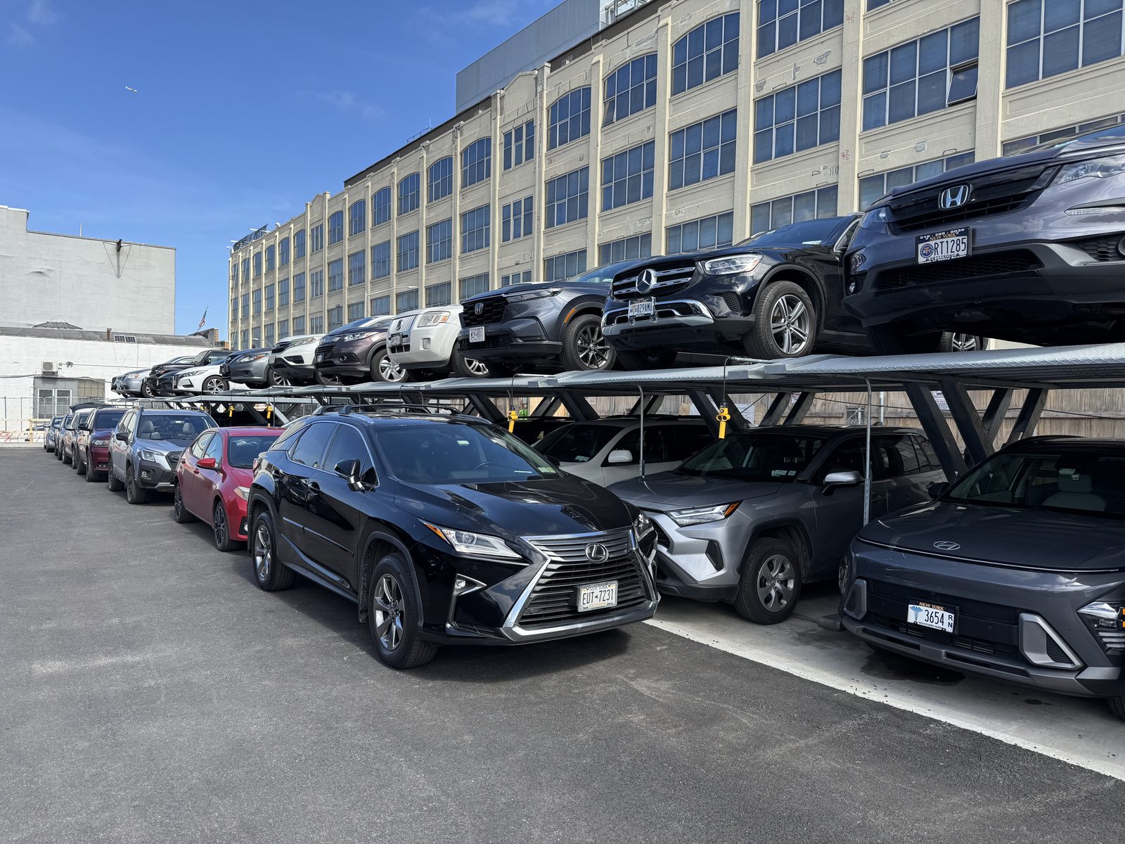 Double Stackers in an open-air lot beside an industrial building in Queens