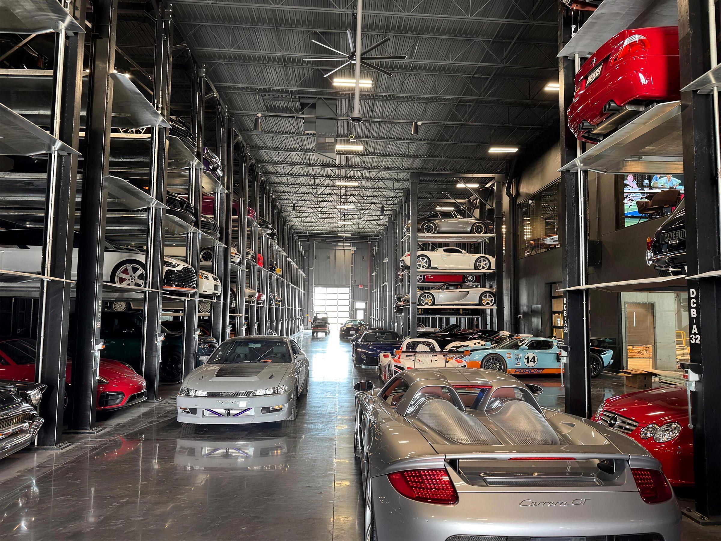 A large indoor facility storing cars on several levels of racking