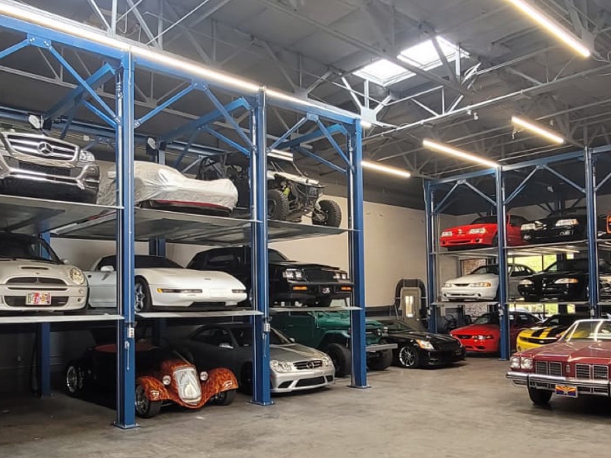 Triple stackers storing vehicles on three levels inside a storage facility
