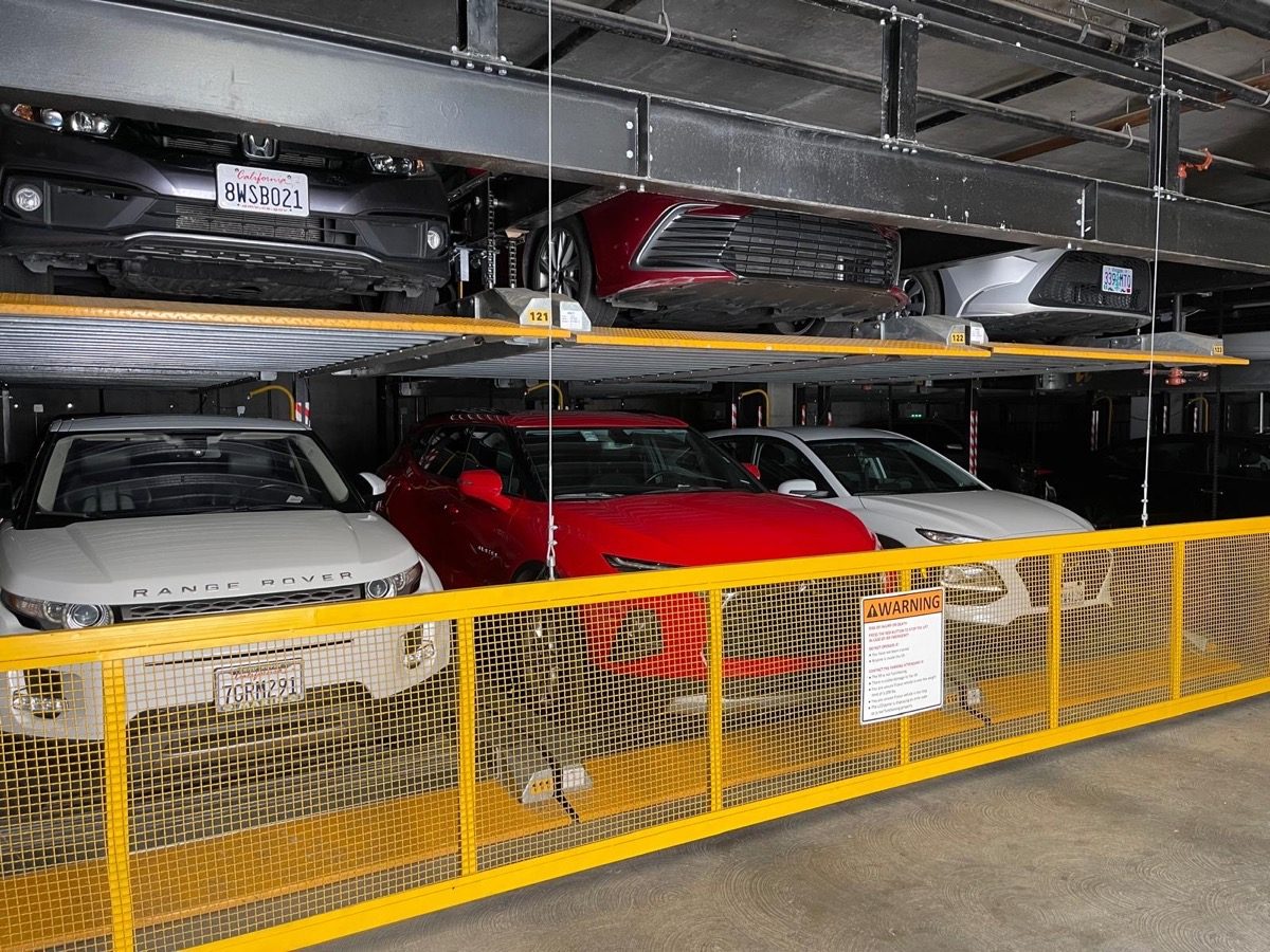 Puzzle parking system holding vehicles on stacked platforms in a residential garage