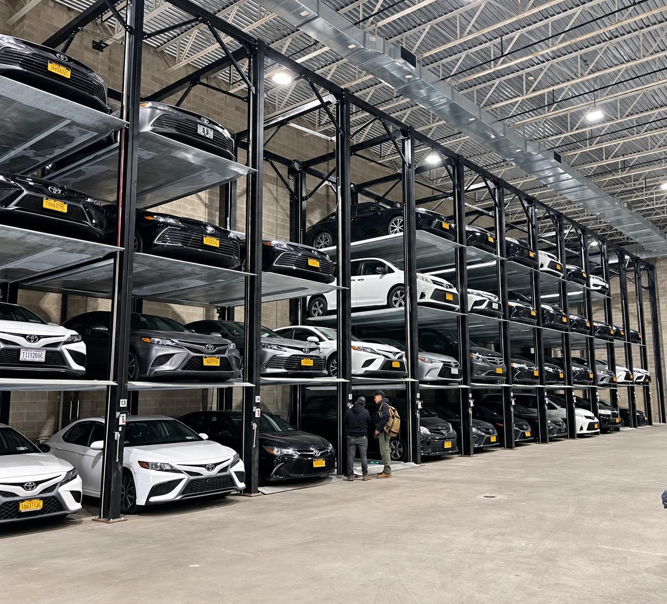 Quad Stackers filled with vehicles inside a garage in the Bronx